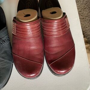 Two pair of Clarks clogs.
